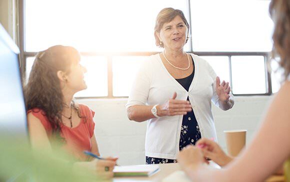 Woman leading a state of the company meeting