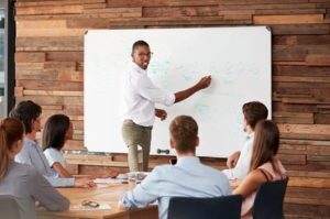 man writing on whiteboard