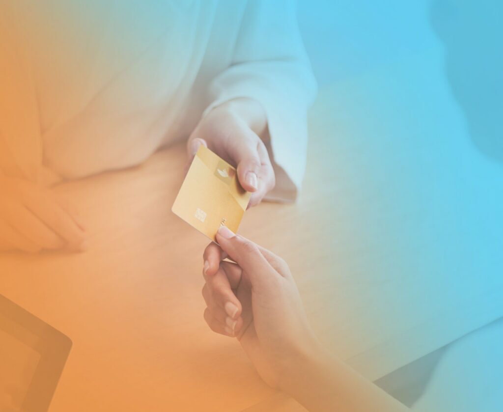 An ideal client passes a credit card to an entrepreneur running on EOS