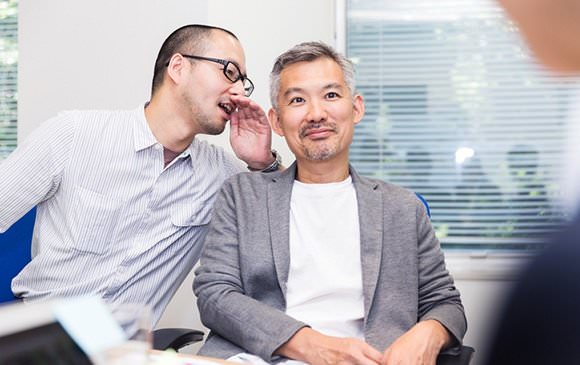 Two men whispering