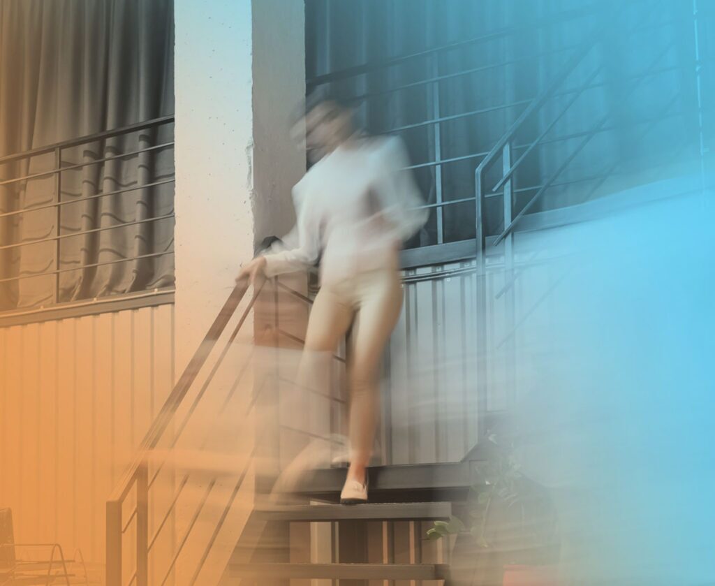 An entrepreneur with motion blur walks down steps