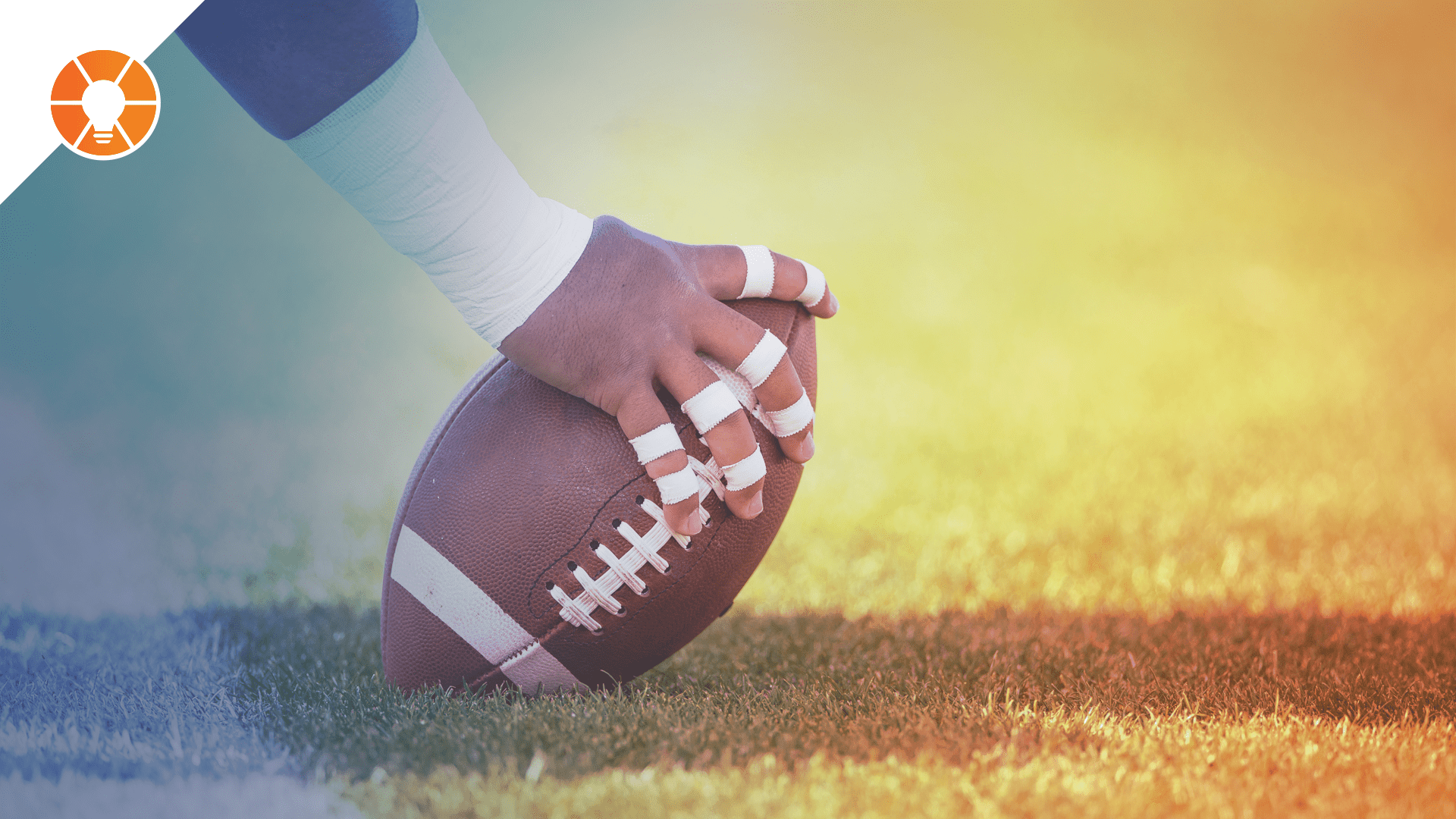 Close up of a center's hands as they prepare to hike a football