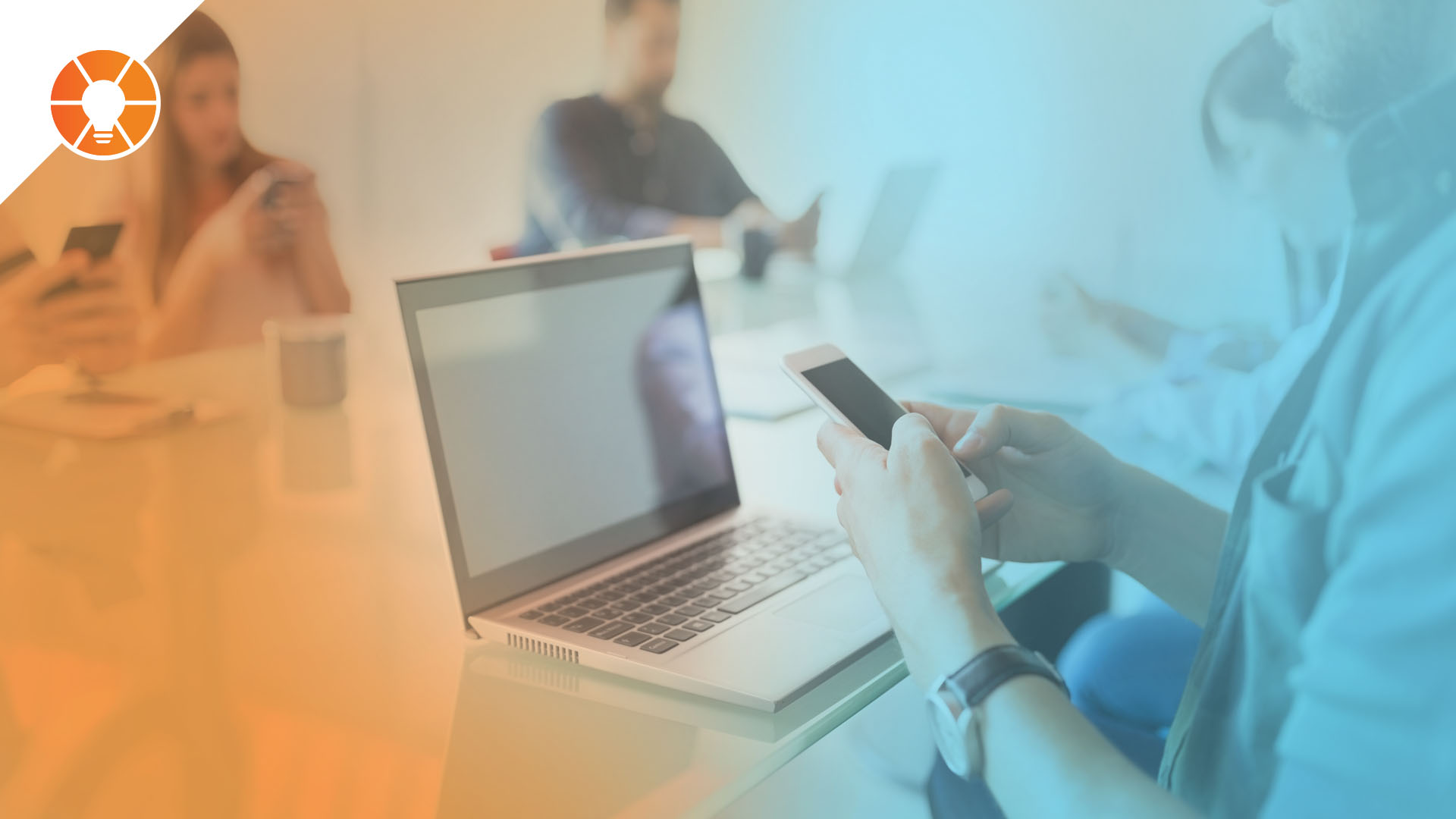 Blurred office meeting scene with team members seated around a conference table using smartphones and laptops, overlaid with orange and blue gradients, illustrating workplace distractions caused by electronics during meetings.