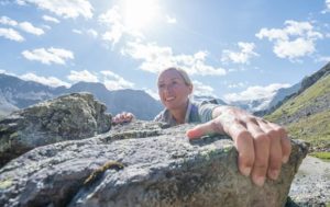 climber gripping a rock