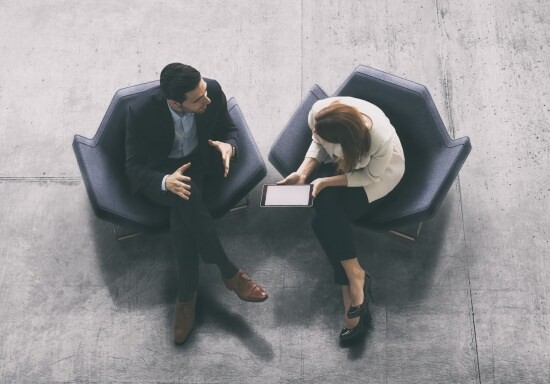 overhead view of businessman giving feedback to an employee