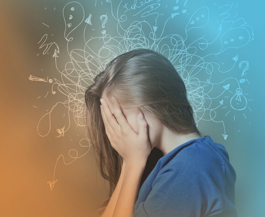 An entrepreneur with their face in their hands thinks about recurring business problems