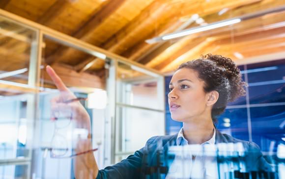 Woman at glass whiteboard