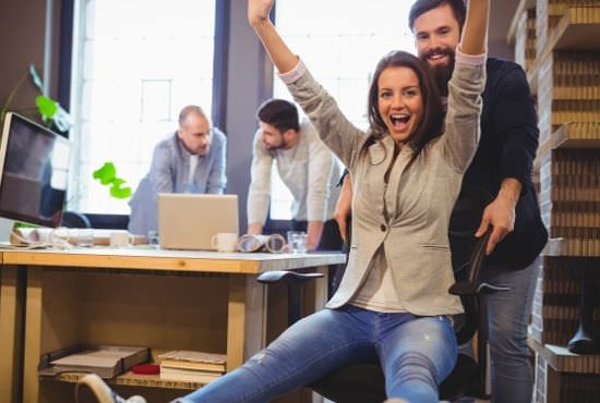 Man pushing a woman on a rolling chair