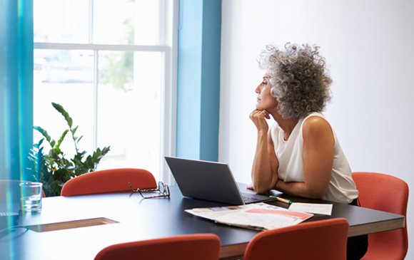 Woman sitting at a table looking out a window