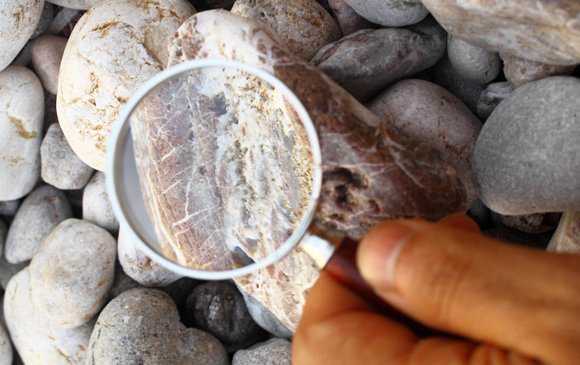 Magnifying glass on rock