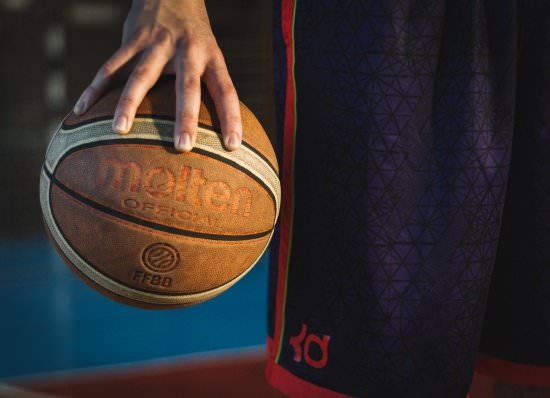 closeup of a basketball player "palming" a basketball