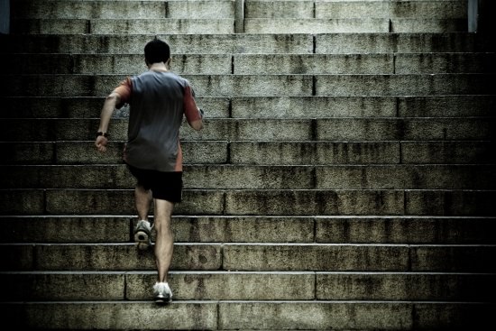 male runner running up stadium steps in training | get team commitment, not compliance
