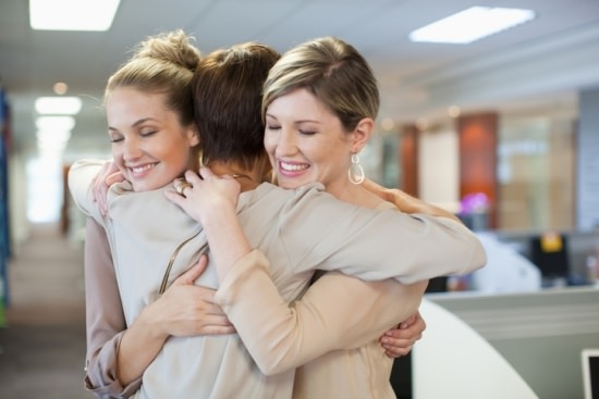 business women hugging for support