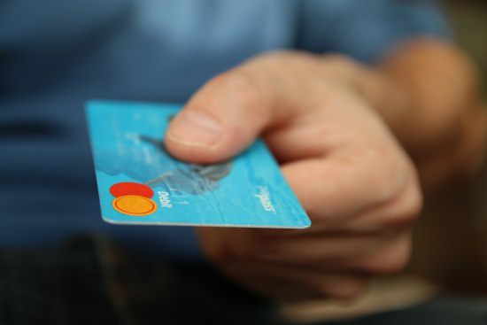 man's hand holding a credit card | gaining buy-in?