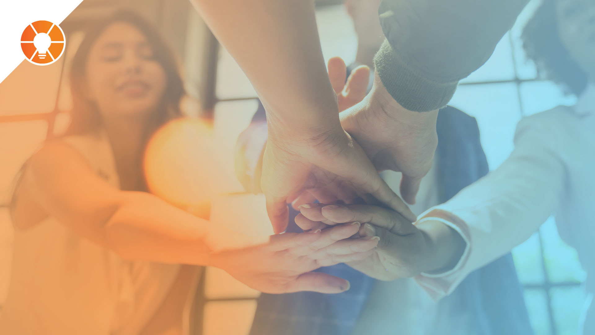 Group of people putting hands on top of each other, representing teamwork