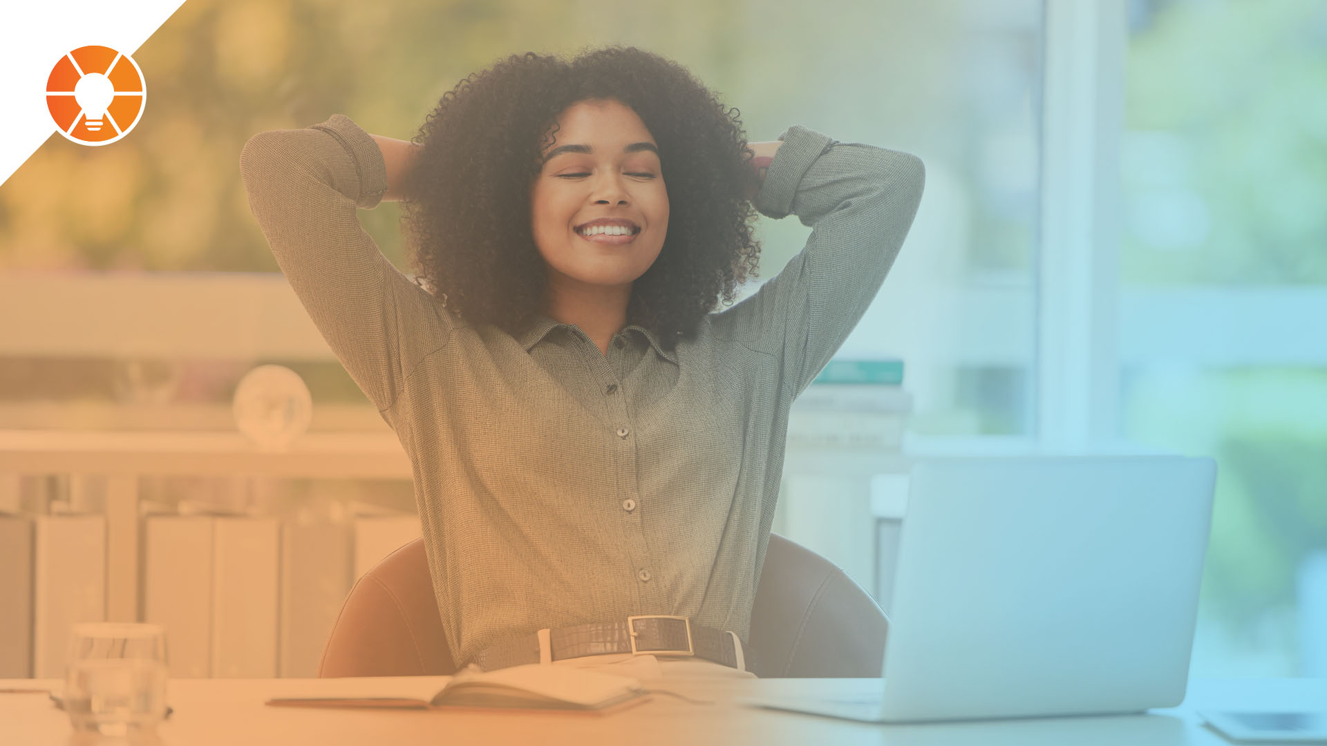 Women leaning back in office chair and smiling in accomplishment
