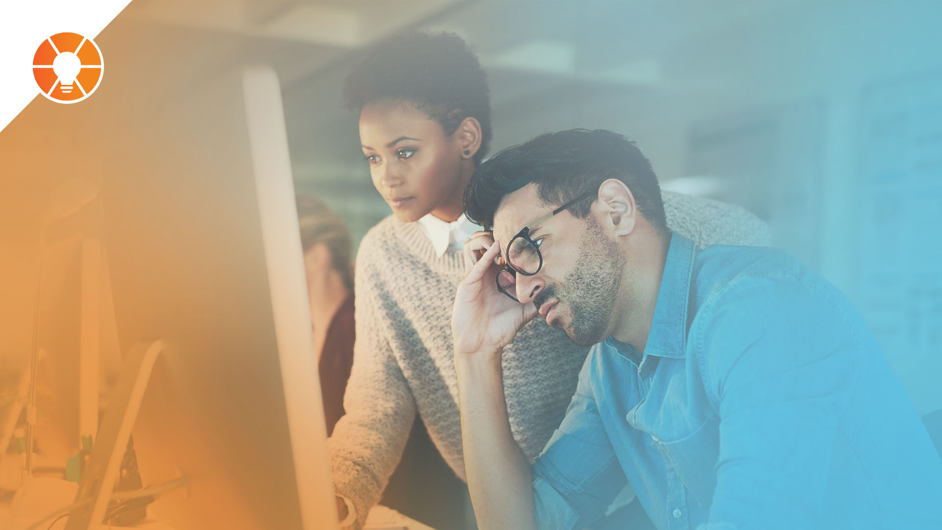 An entrepreneur and team member look at a compute screen